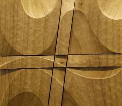 A dimensional wood sculpture with sanded curves and sharp cuts, by Monica Setziol-Phillips