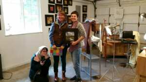 Katia Kyte posing other two other people in their artist studio